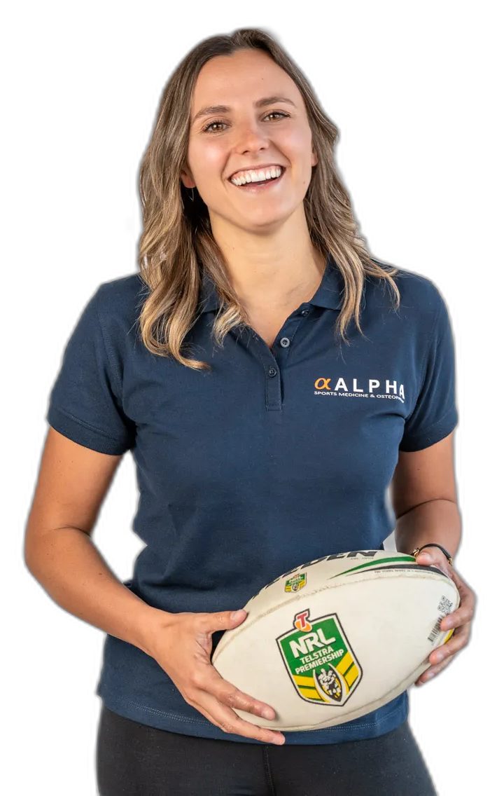 Alpha Sports Medicine practitioner smiling, holding a rugby ball